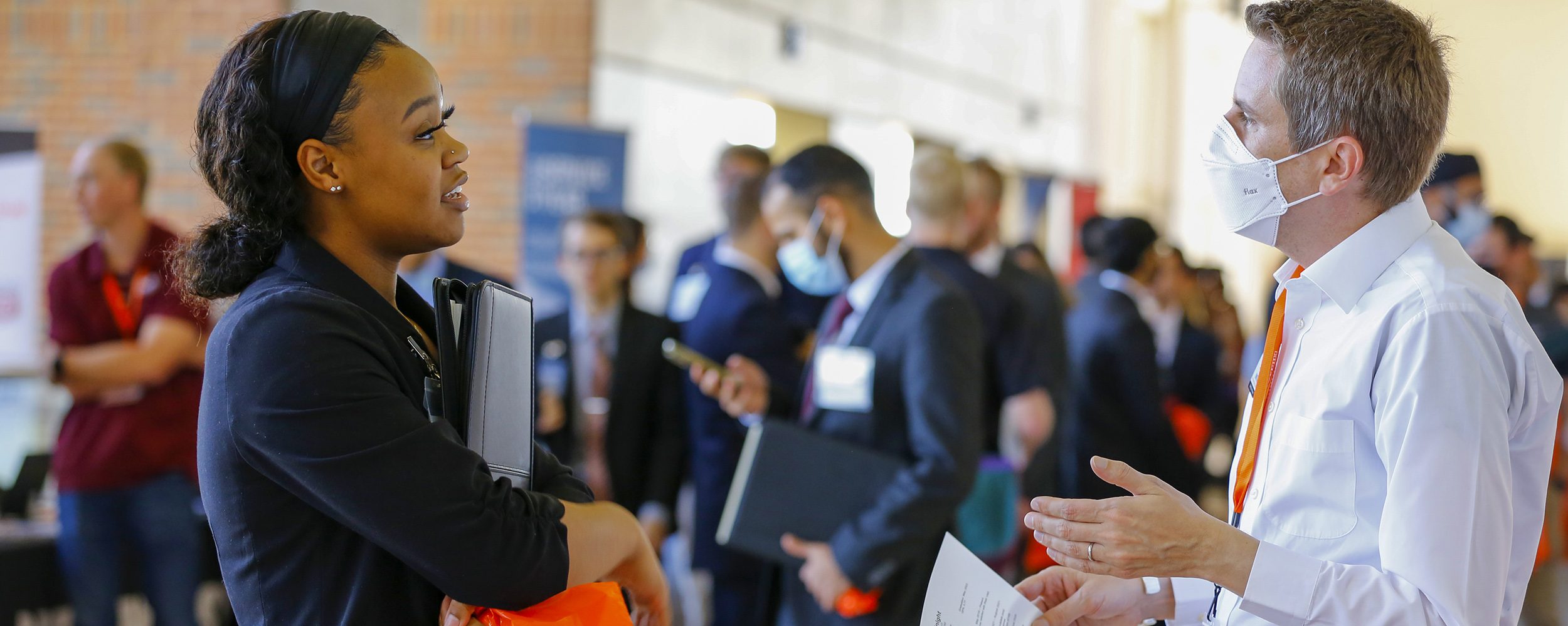Students networking with recruiters at the career fair. 