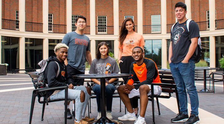 students sitting in front of Spears building