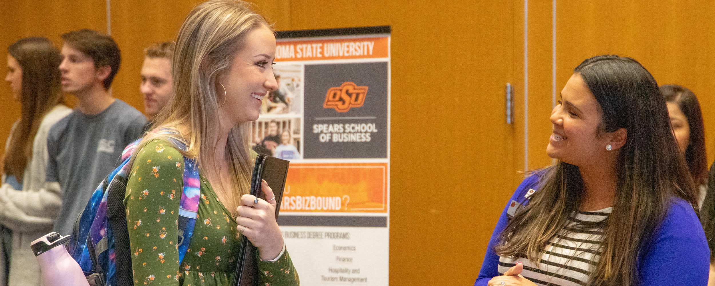 A female student networking with a recruiter. 