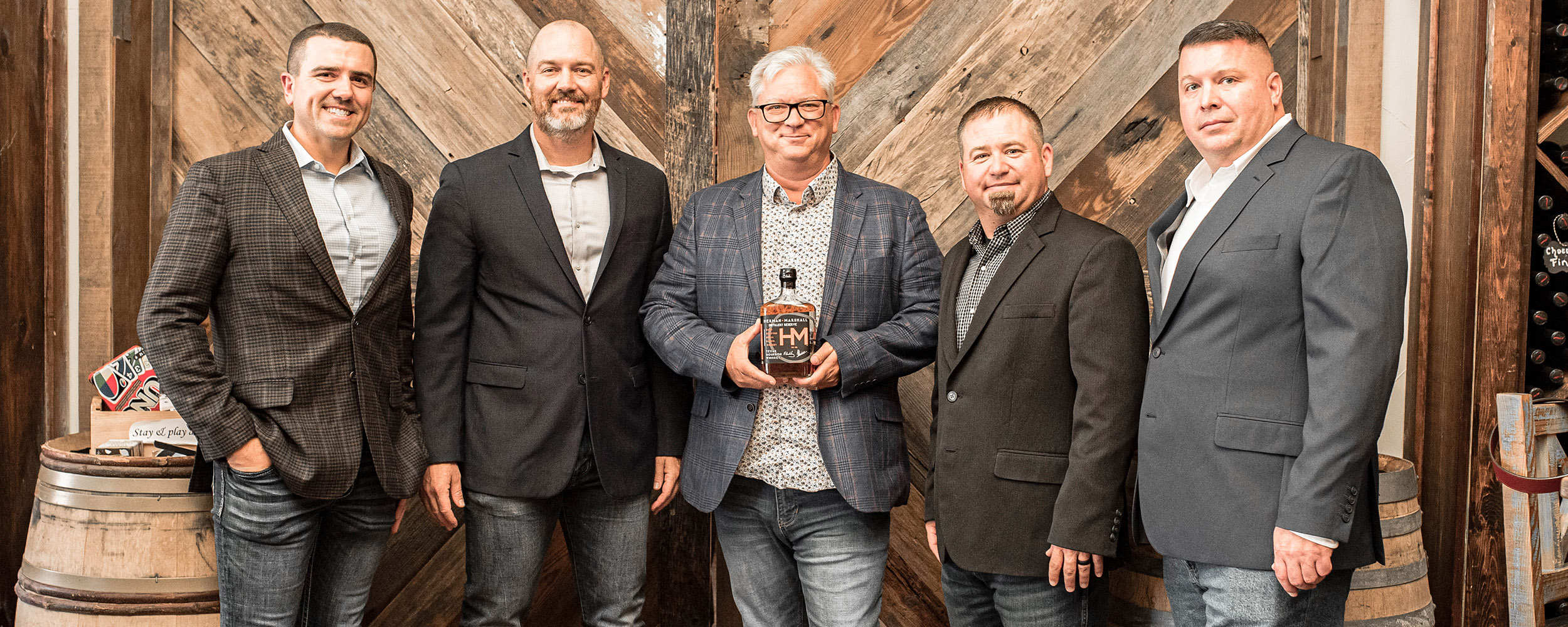 Ryan Hamar, left, and others with their whiskey. 