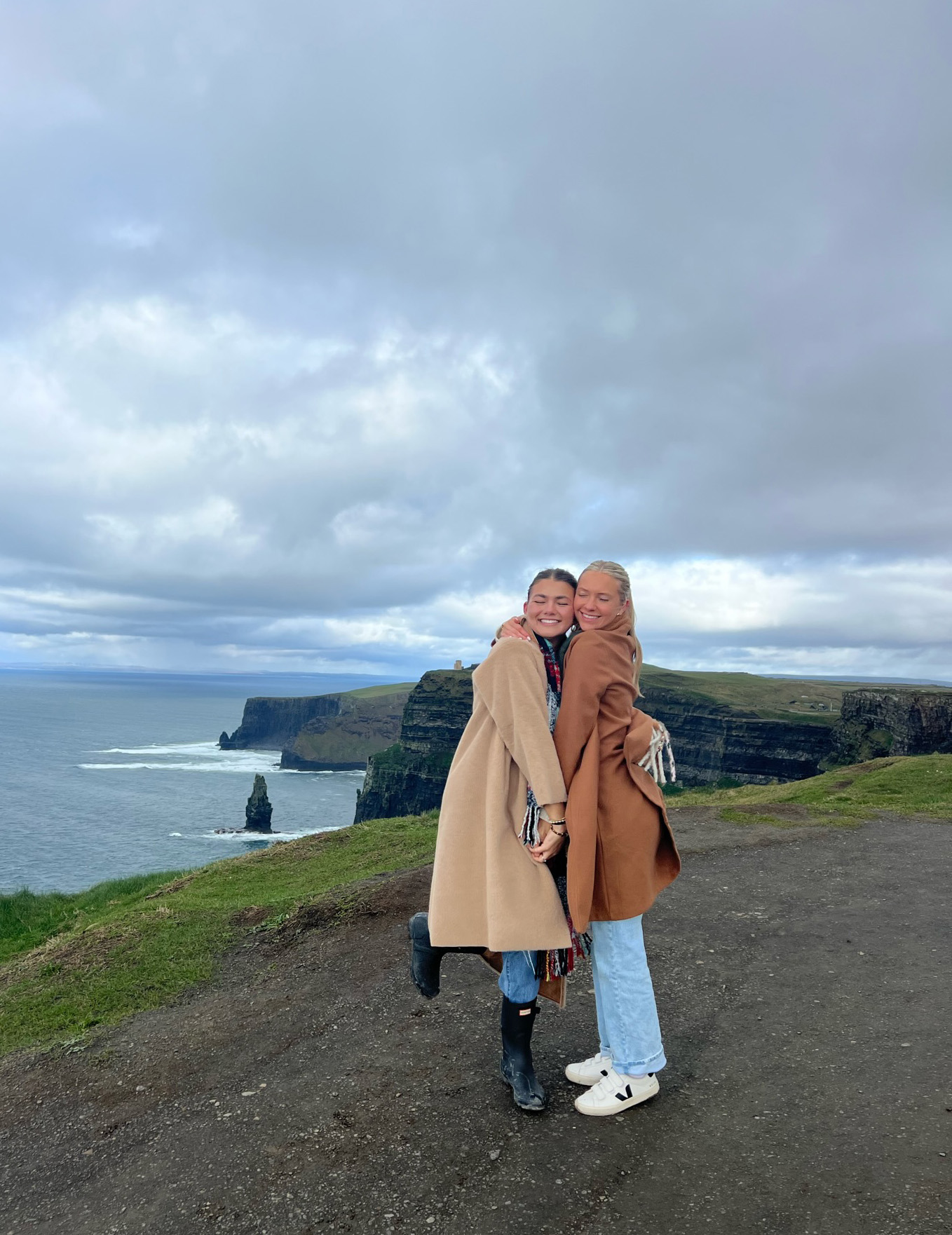 Two Cagle students in Ireland posing in front of shoreline
