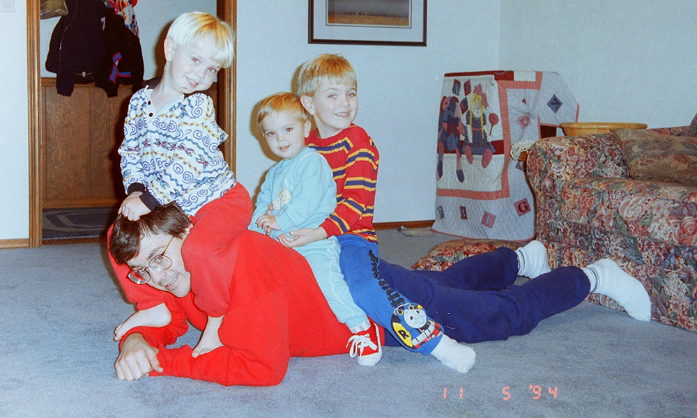 Ken Eastman roughhousing with his sons