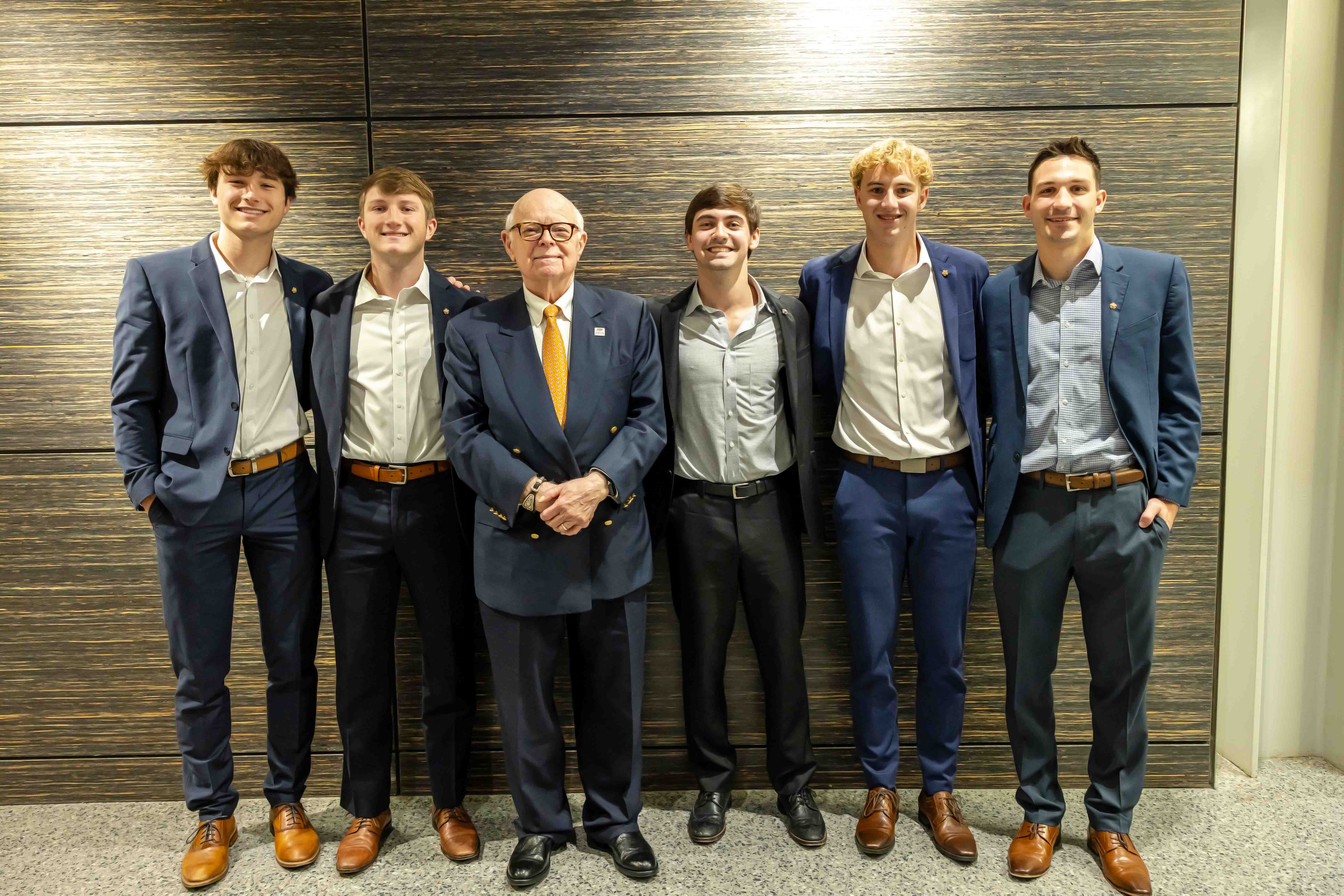Dr. Spears and a group of students dressed professionally and smiling