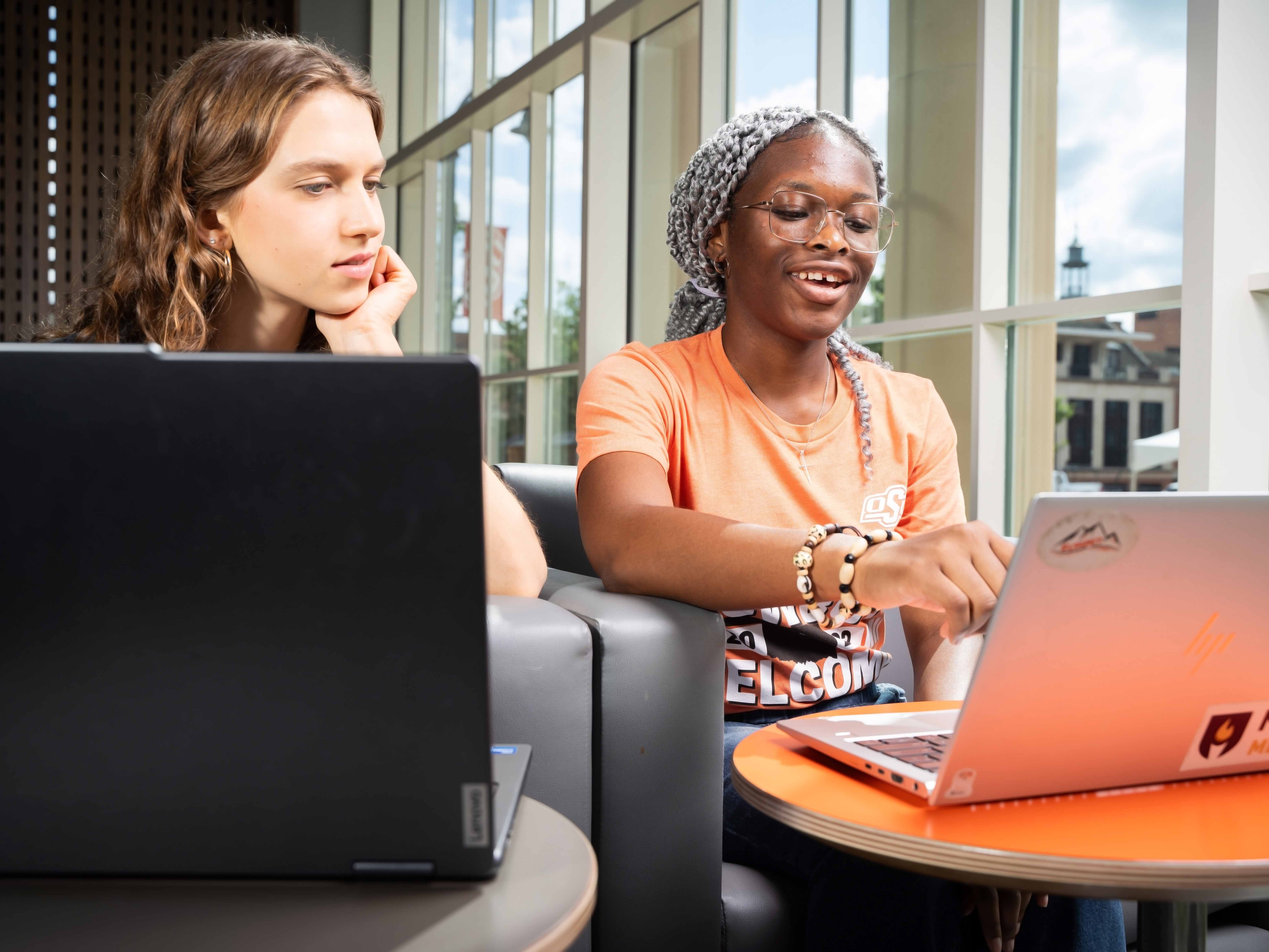 Two female students looking at a computer
