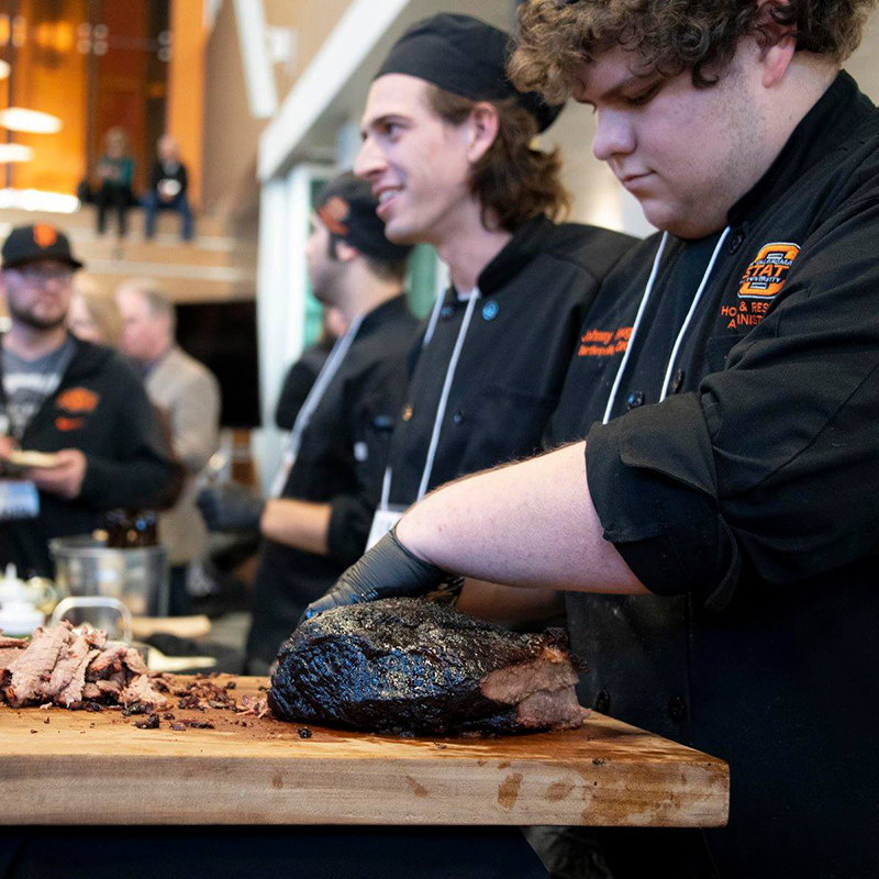 student cutting brisket student cutting brisket
