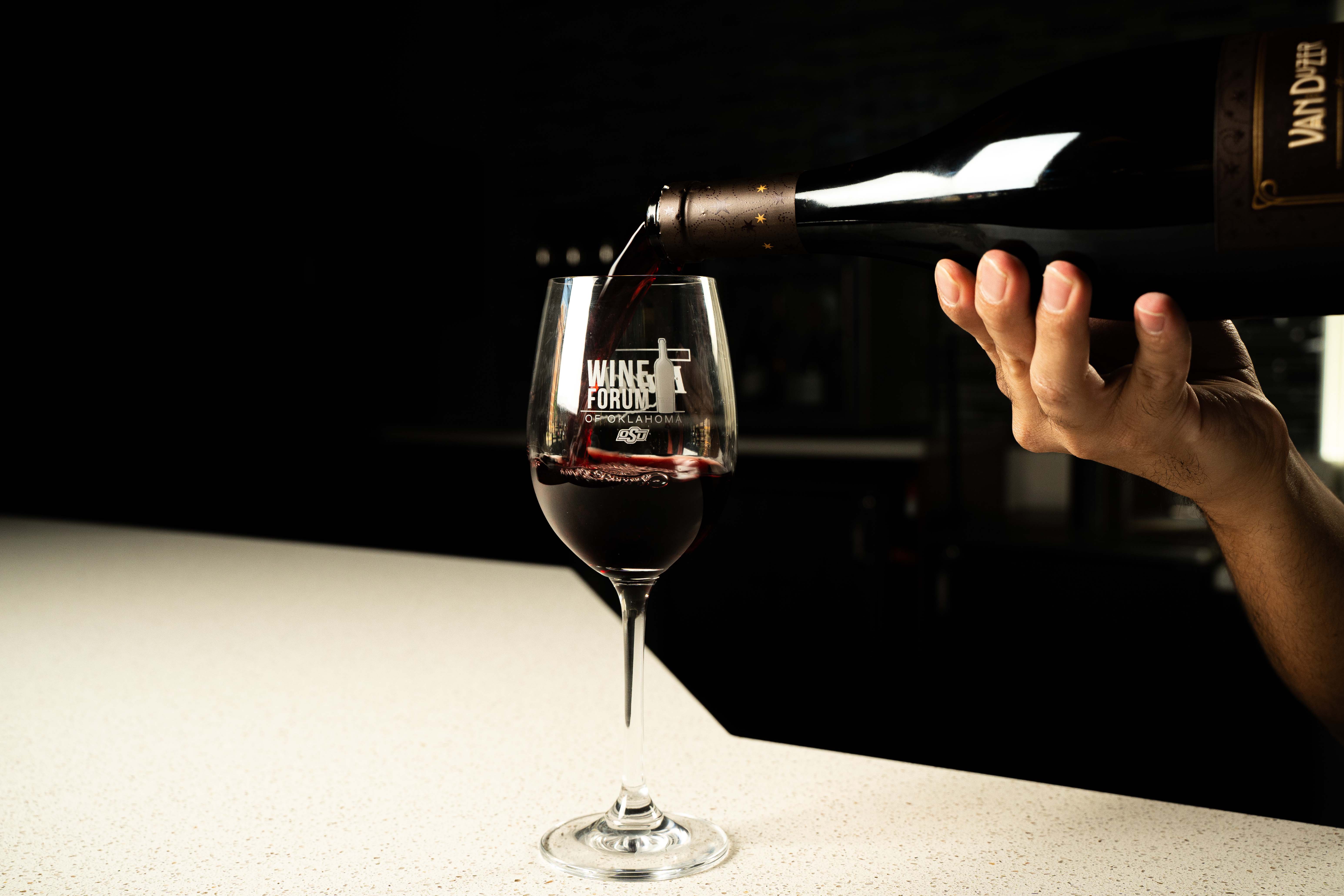 Wine being poured into bottle that says