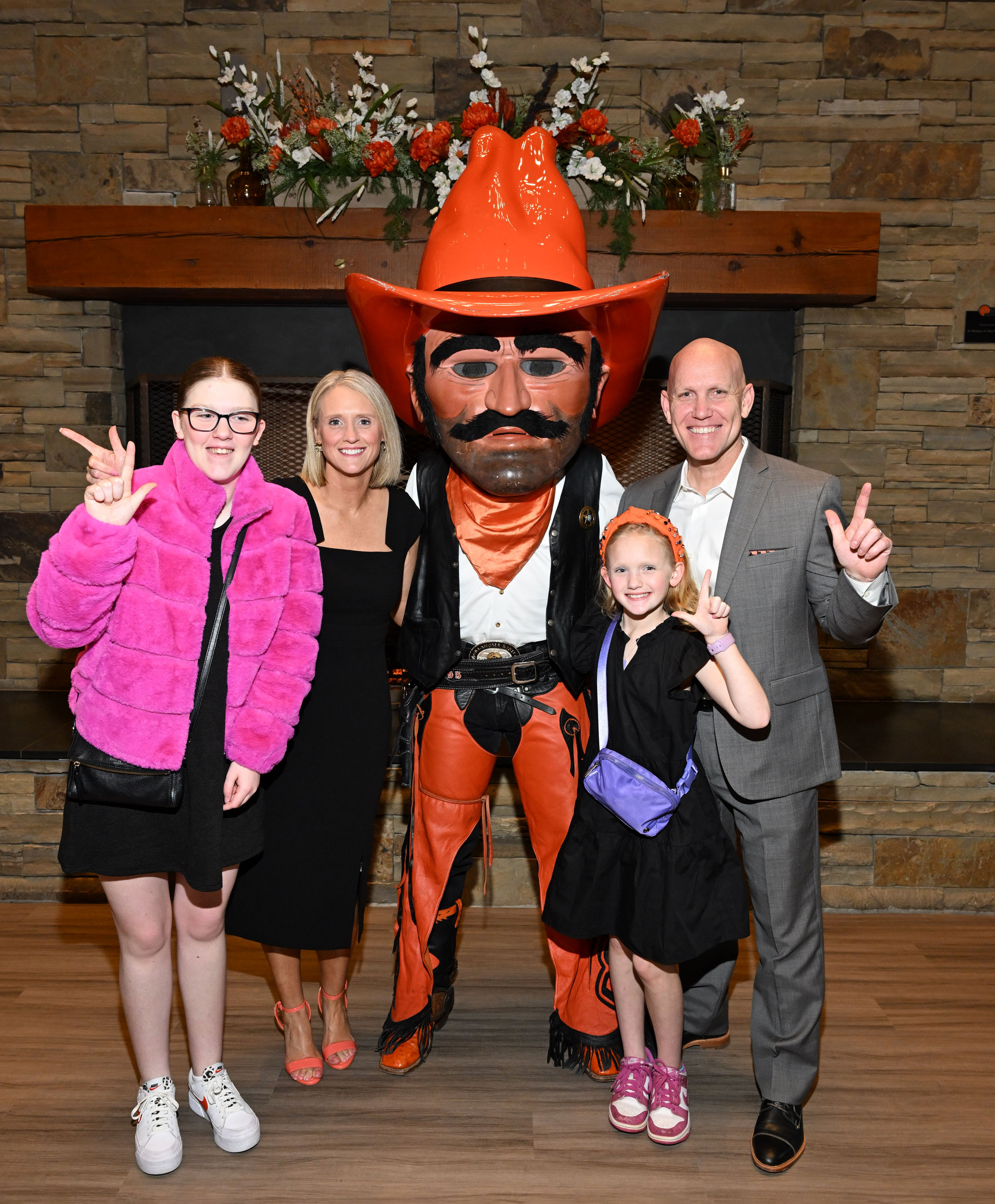 Alumni and family standing with Pistol Pete Alumni and family standing with Pistol Pete