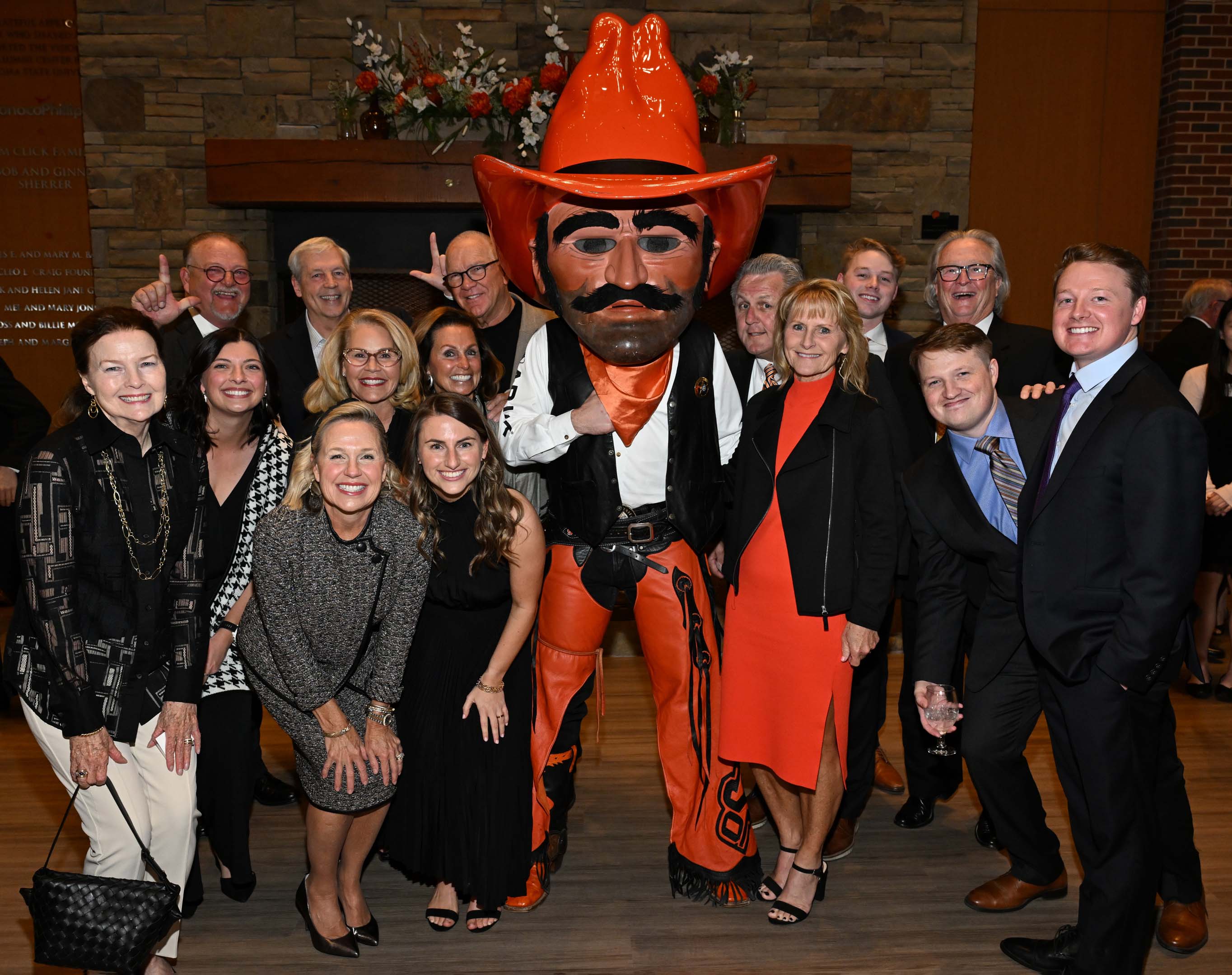 Large family standing with Pistol Pete in the alumni center lobby Large family standing with Pistol Pete in the alumni center lobby