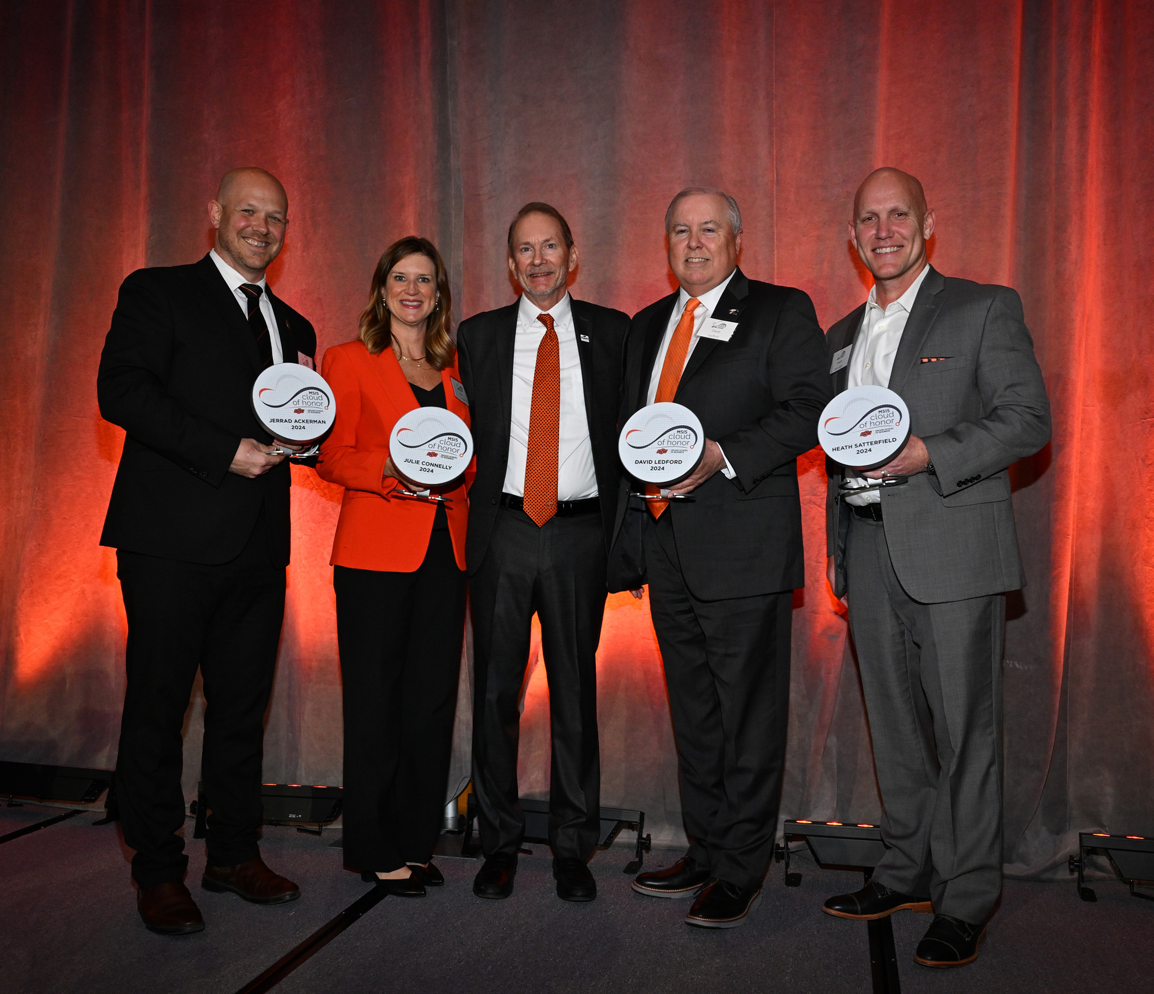 Cloud of Honor inductees standing on stage holding awards with Rick Wilson, dean of the School of Management Information Systems Cloud of Honor inductees standing on stage holding awards with Rick Wilson, dean of the School of Management Information Systems