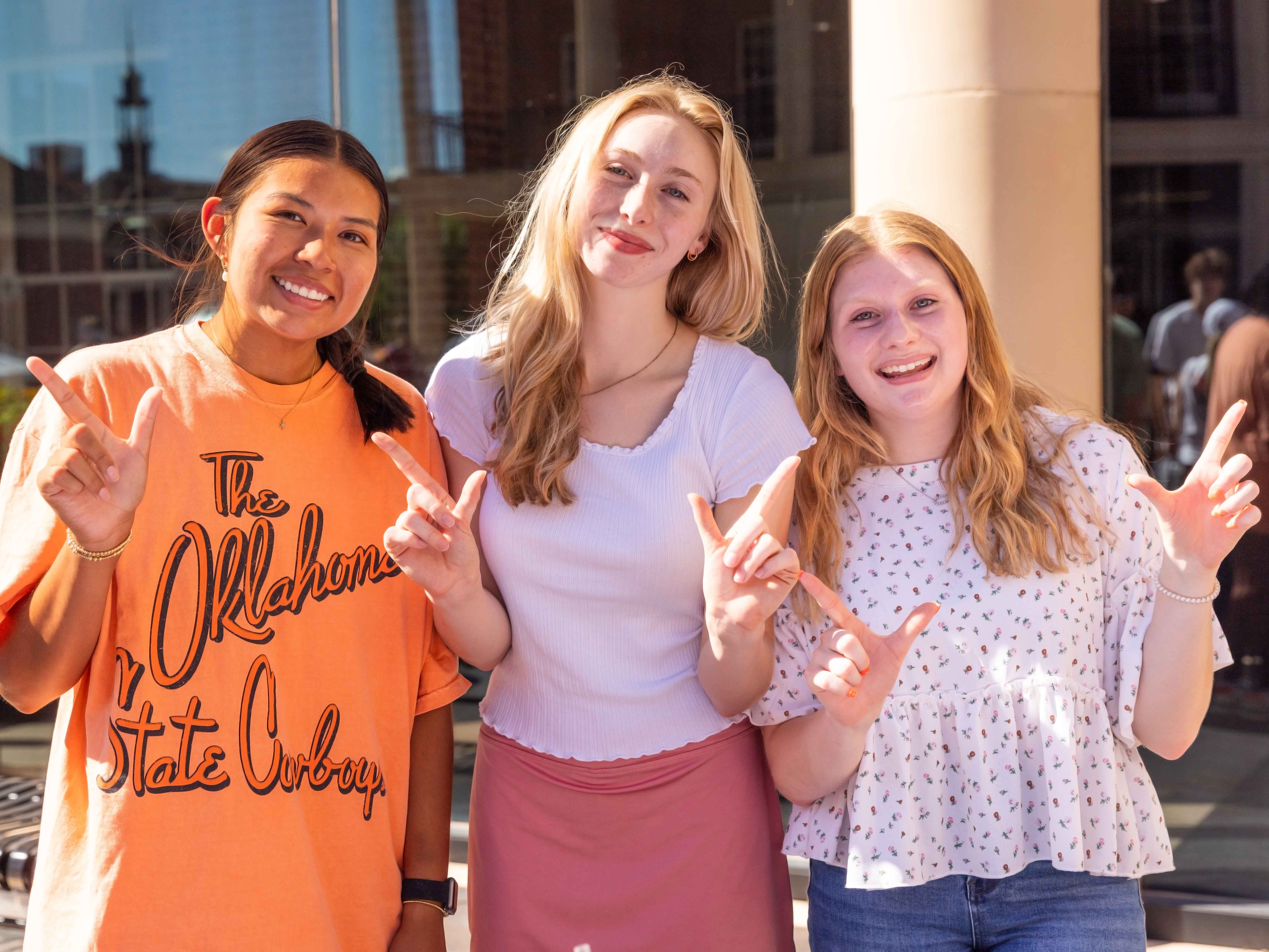Three female students smiling with a 