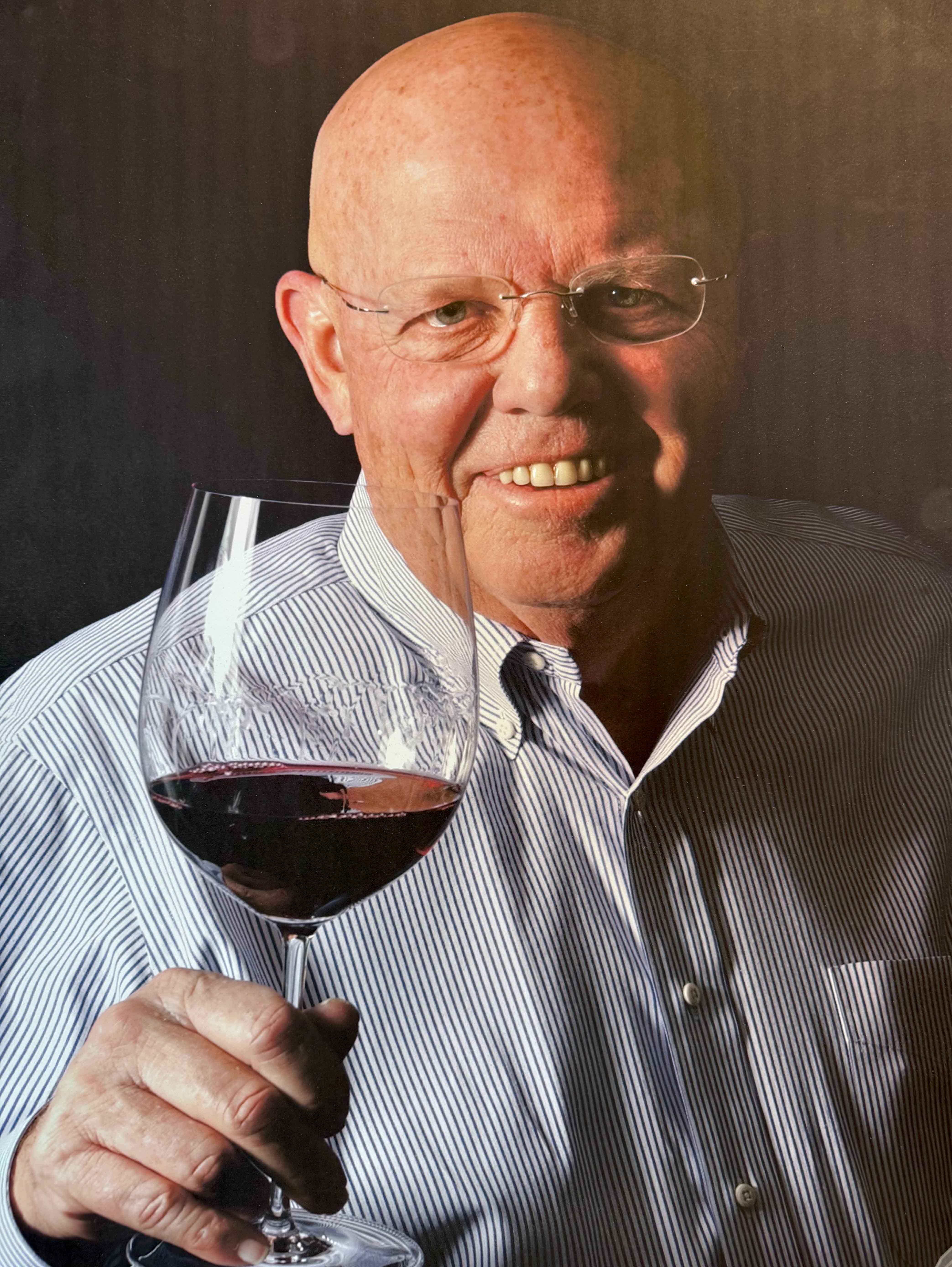 Photo of Wayne Hirst holding a glass of wine