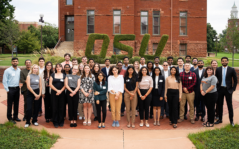 Members of the 2024 MS BAnDS cohort stand in front of topiary letters that spell OSU.