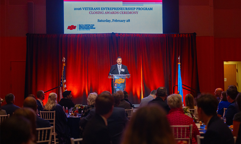 The keynote speaker for the VEP speaking to the group at the front of the banquet hall