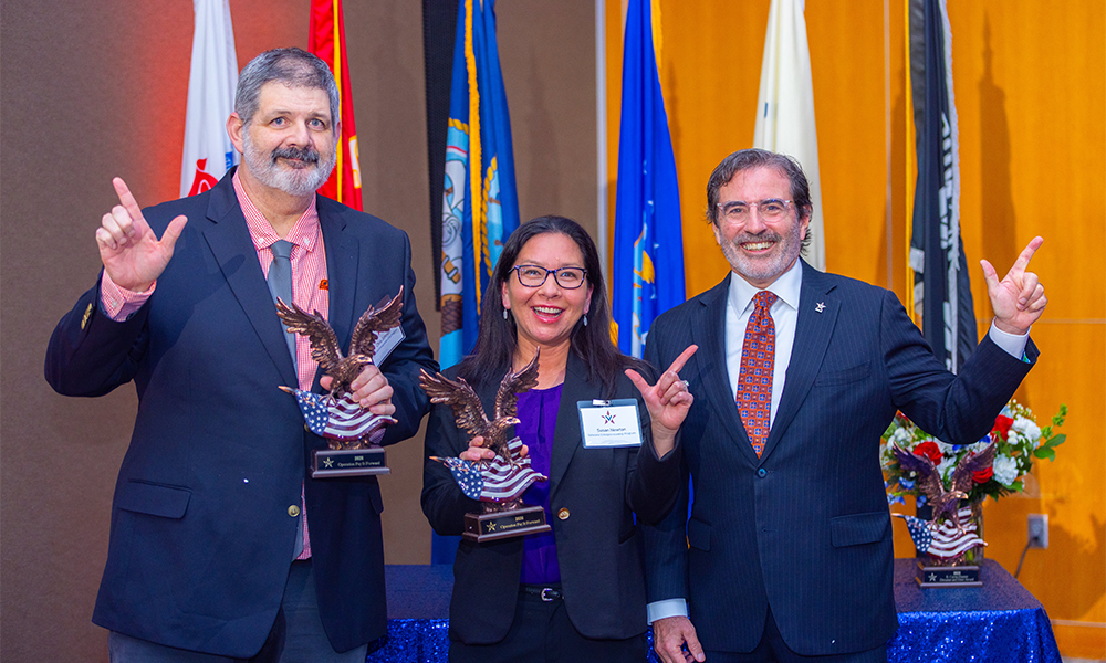 VEP honorees pose with their awards alongside Spears Business assistant dean Marc Tower
