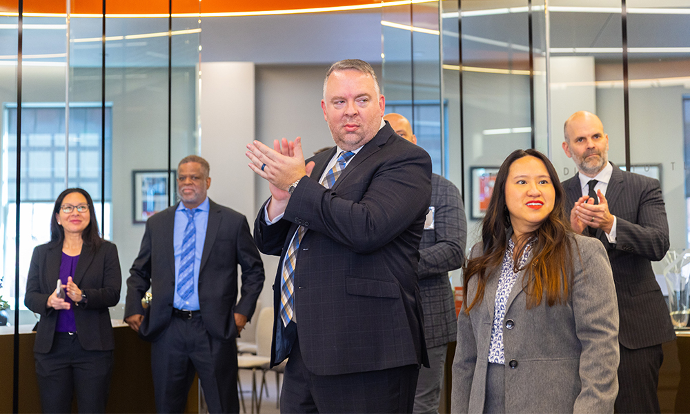 A group of VEP participants applaud a fellow participant.