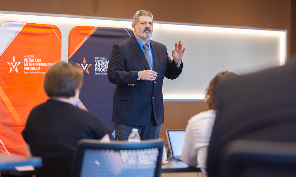 A VEP participant raises his left hand during his pitch to judges.