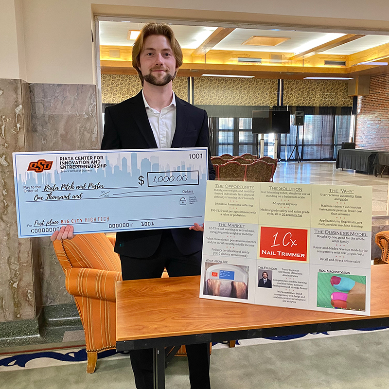 Trevor Fogleman with his winnings at the Pitch and Poster Competition.